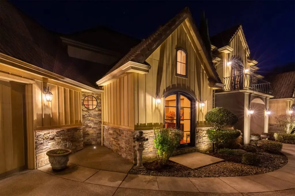 An elegant house at night illuminated by well placed exterior lights highlighting architectural details and landscaping - Enhance Your Home with Effective Front of House Lighting Positions - Vorlane - Vorlane An elegant house at night illuminated by well placed exterior lights highlighting architectural details and landscaping - Enhance Your Home with Effective Front of House Lighting Positions - Vorlane - Vorlane